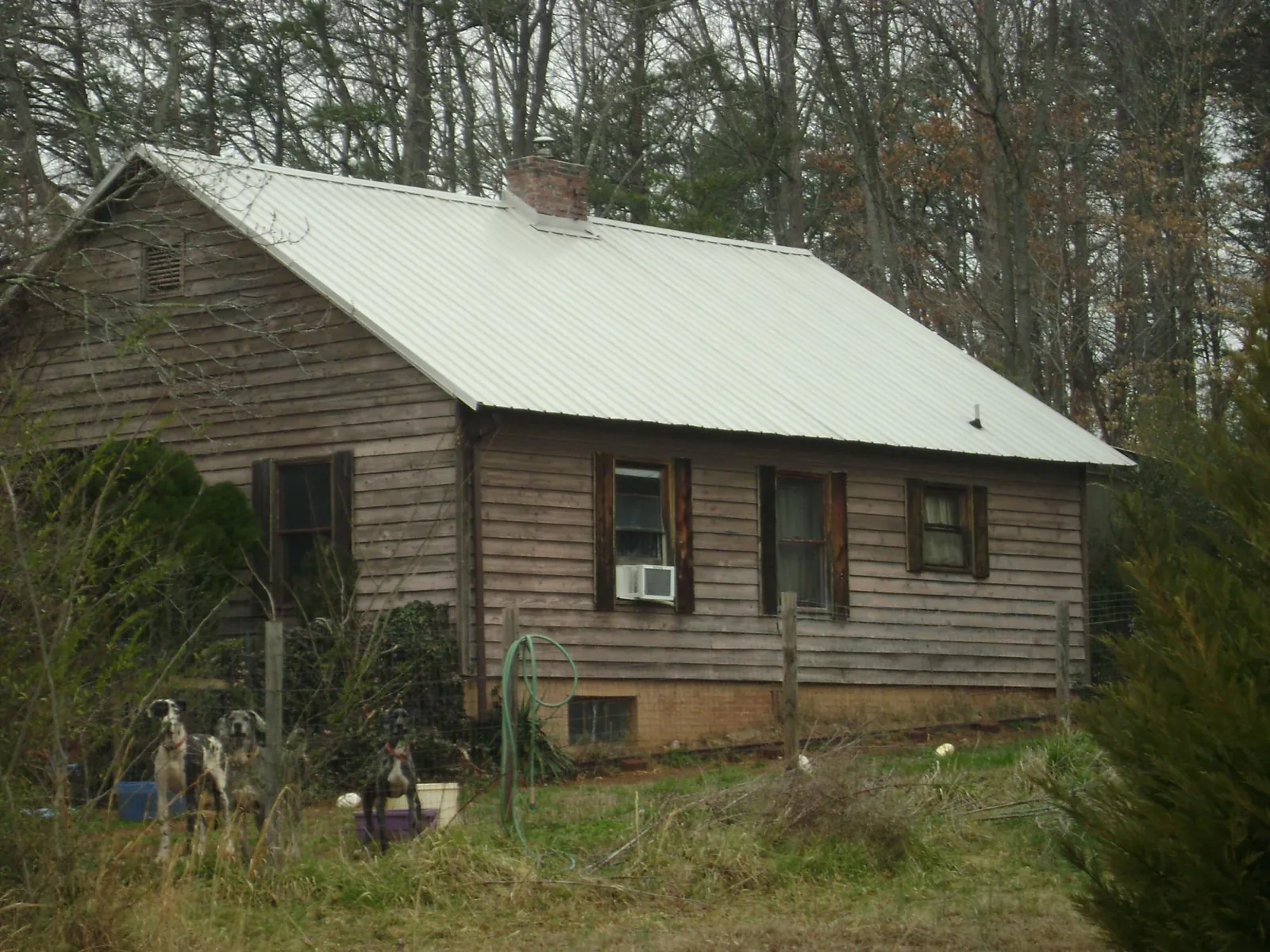 White metal roof on an old wood sided farmhouse, from a Metal Roof Installation job in Willington